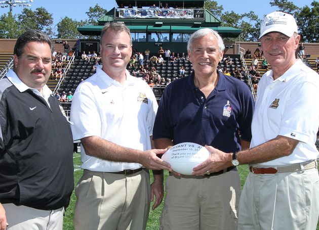 Bryant football coach Marty Fine, Director of Athletics Bill Smith and university President Ronald K. Machtley present Patrick Nassaney with the game ball prior to start of the Nassaney Race on Sept. 10, 2011 (www.dspics.com)